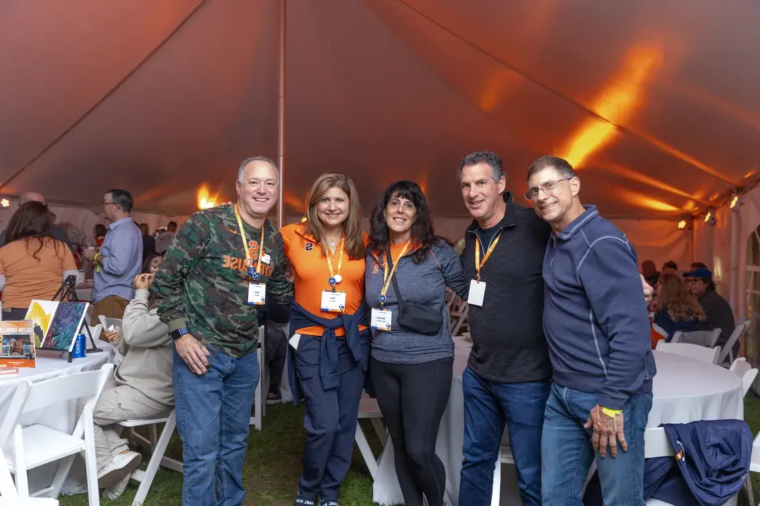 Alumni during Orange Central standing together.